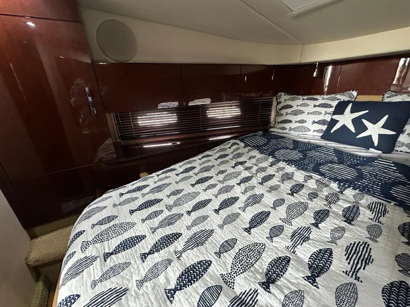Slide: The Image of Luxurious cabin interior of 2010 Sea Ray 470 Sundancer with nautical-themed bedding. - 35