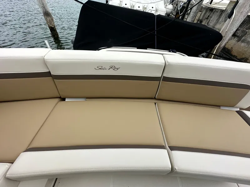 Slide: The Image of 2010 Sea Ray 470 Sundancer boat seating with beige and white upholstery. - 7