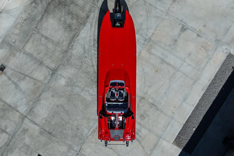 Slide: The Image of Overhead view of a 2008 Nor-Tech 3600 Supercat, vibrant red, on concrete surface. - 10