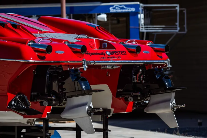 Slide: The Image of 2008 Nor-Tech 3600 Supercat boat, rear view with dual engines and vibrant red finish. - 14