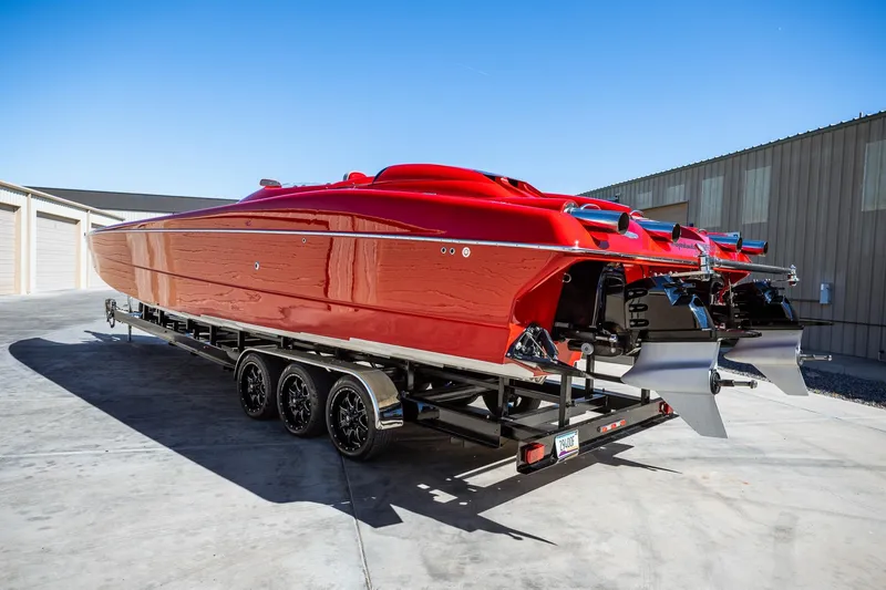 Slide: The Image of 2008 Nor-Tech 3600 Supercat in vibrant red on a trailer, parked outdoors. - 18