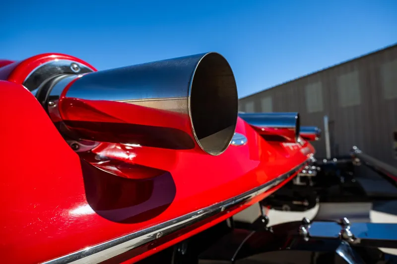 Slide: The Image of Close-up of a 2008 Nor-Tech 3600 Supercat exhaust pipes, showcasing sleek red design. - 19