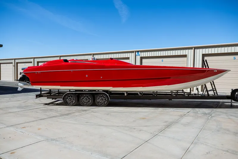 Slide: The Image of 2008 Nor-Tech 3600 Supercat in vibrant red on a trailer, parked outdoors. - 2