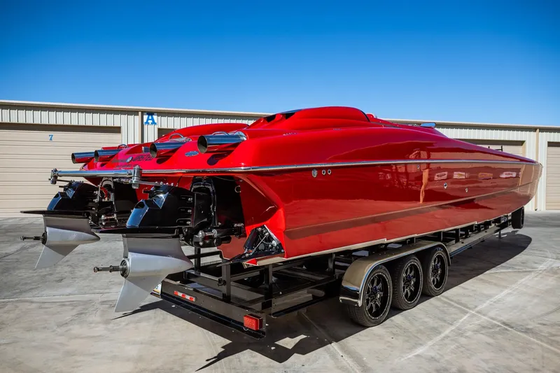 Slide: The Image of 2008 Nor-Tech 3600 Supercat in vibrant red on a trailer, showcasing sleek design and powerful engines. - 21