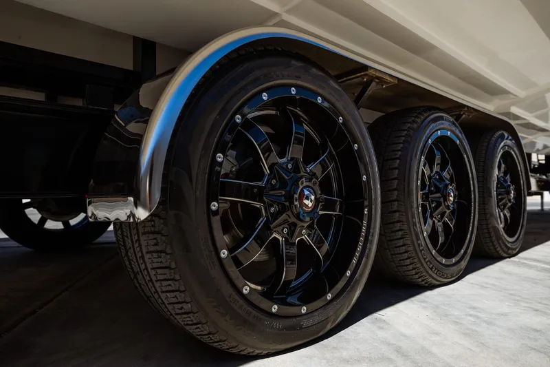 Slide: The Image of Close-up of 2008 Nor-Tech 3600 Supercat trailer wheels with sleek black rims. - 22