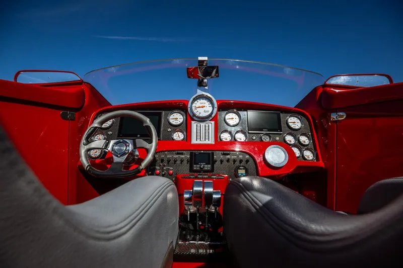 Slide: The Image of 2008 Nor-Tech 3600 Supercat cockpit with red dashboard and multiple gauges under clear blue sky. - 23