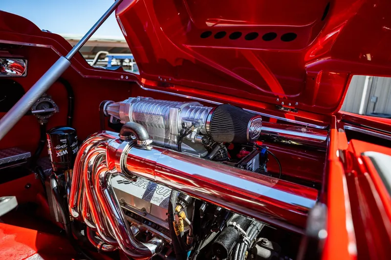 Slide: The Image of 2008 Nor-Tech 3600 Supercat engine compartment with polished components and red accents. - 30