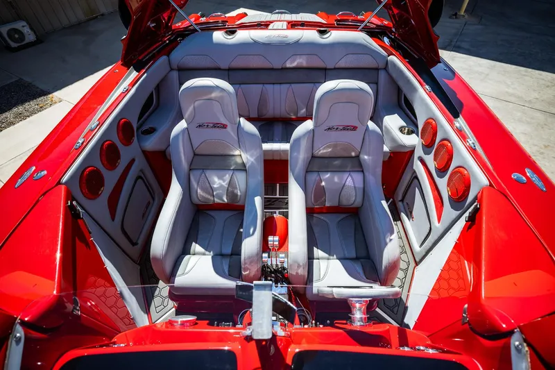 Slide: The Image of Interior of a 2008 Nor-Tech 3600 Supercat, featuring red and gray seating. - 31