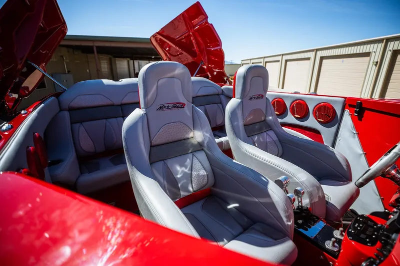 Slide: The Image of 2008 Nor-Tech 3600 Supercat interior with red and gray seating, showcasing luxury design. - 32