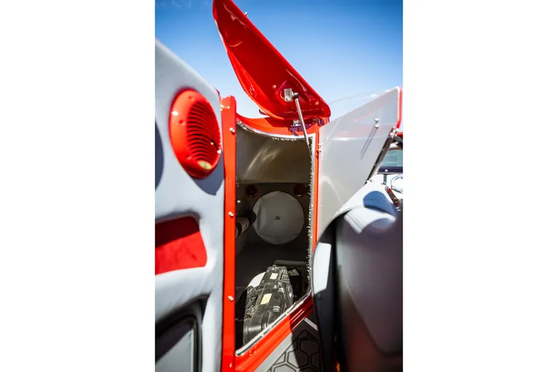 Slide: The Image of 2008 Nor-Tech 3600 Supercat interior storage compartment with red accents and open hatch. - 42