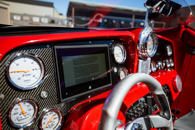 Slide: The Image of Dashboard of a 2008 Nor-Tech 3600 Supercat with gauges and a digital display. - 44