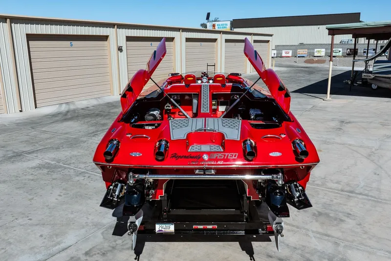 Slide: The Image of Red 2008 Nor-Tech 3600 Supercat boat with open engine hatches in a storage area. - 7