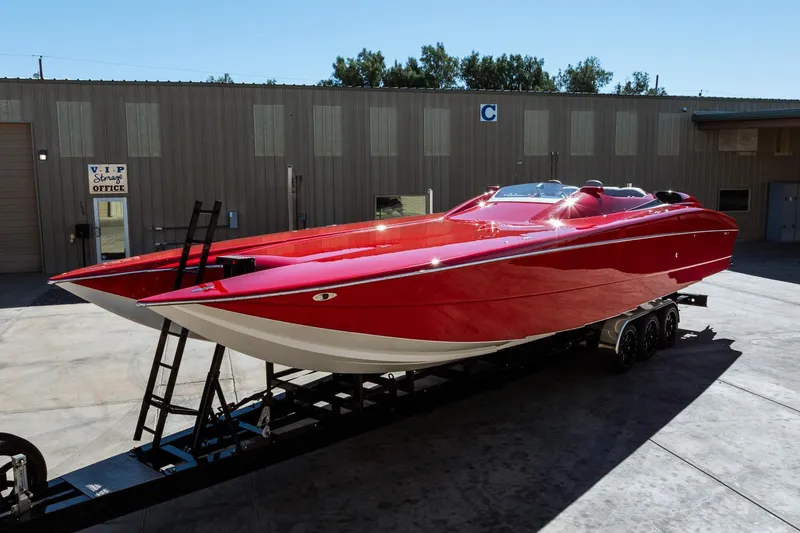 Slide: The Image of Red 2008 Nor-Tech 3600 Supercat boat on trailer outside storage facility. - 8
