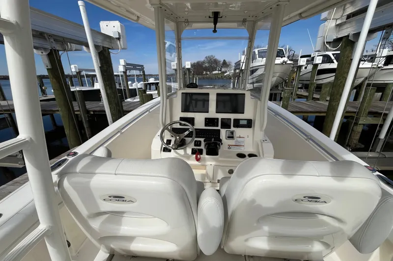 Slide: The Image of 2020 Cobia 301 Center Console boat interior with dual seats and navigation controls. - 10