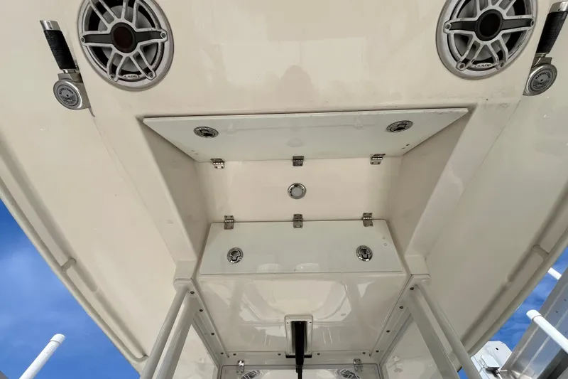 Slide: The Image of 2020 Cobia 301 Center Console boat, featuring speakers and storage compartments. - 12