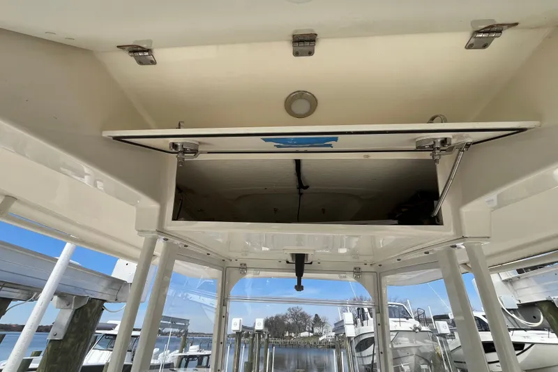 Slide: The Image of Open storage compartment on a 2020 Cobia 301 Center Console boat. - 13