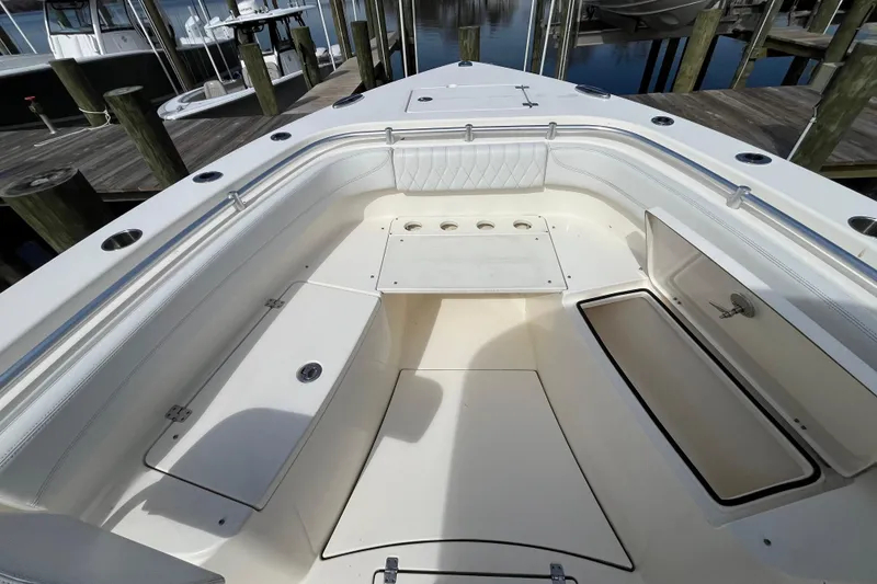 Slide: The Image of 2020 Cobia 301 Center Console boat interior with storage compartments and seating. - 18