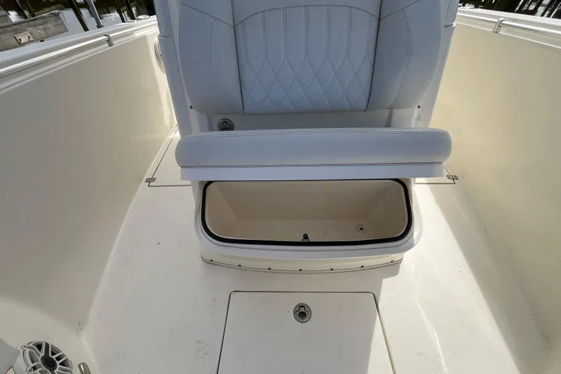 Slide: The Image of 2020 Cobia 301 Center Console boat with open storage compartment under seat. - 19