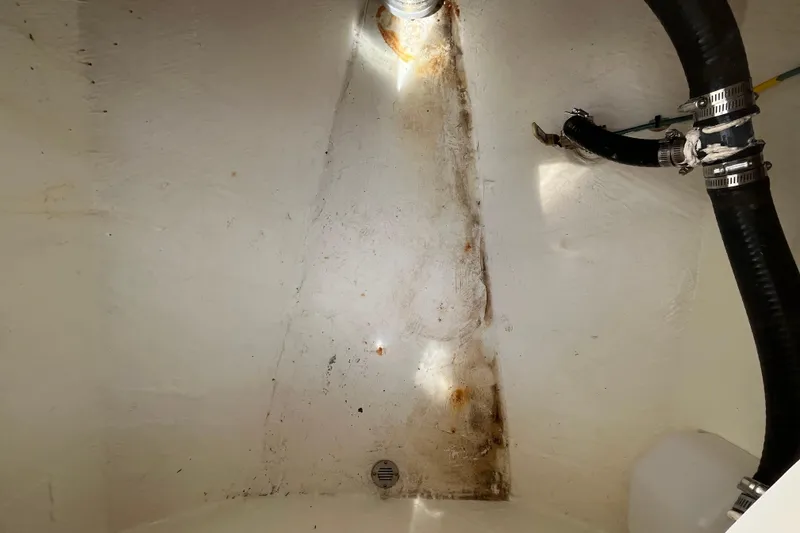 Slide: The Image of 2020 Cobia 301 Center Console bilge area with hoses and drainage. - 22