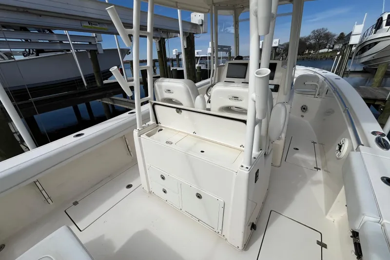Slide: The Image of 2020 Cobia 301 Center Console boat interior with helm and seating area. - 3