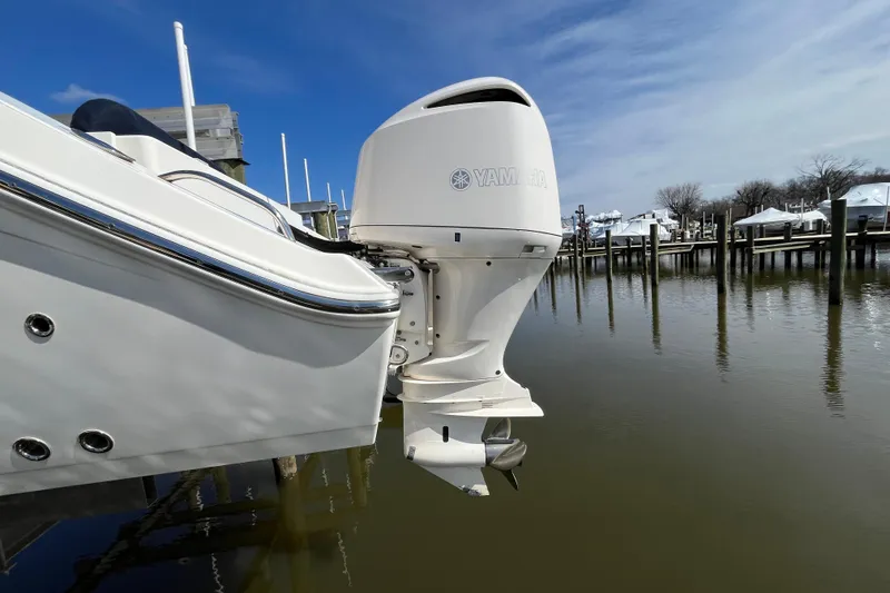 Slide: The Image of 2020 Cobia 301 Center Console with Yamaha outboard motor at marina. - 5
