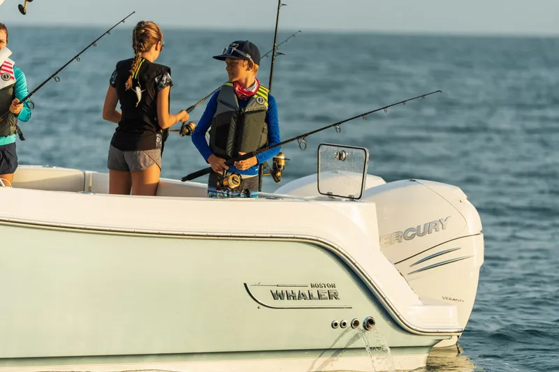 Slide: The Image of Two people are fishing on a Boston Whaler 325CQ boat at sea. - 26