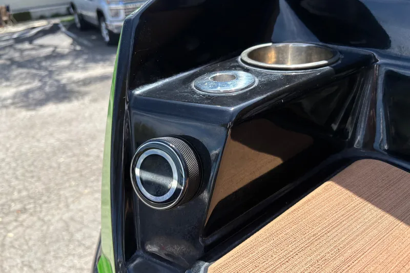 Slide: The Image of 2023 Supra SL 400 boat detail with cup holder and control knob. - 11