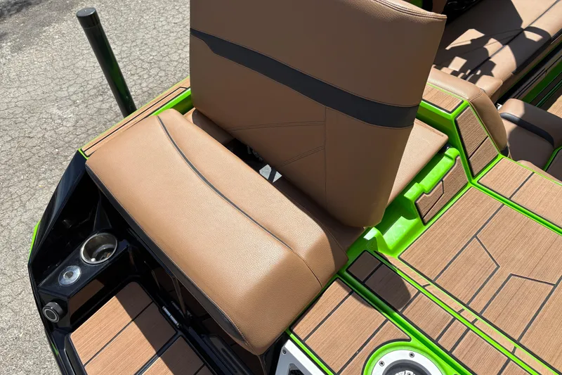 Slide: The Image of 2023 Supra SL 400 boat interior with tan seats and green accents. - 13