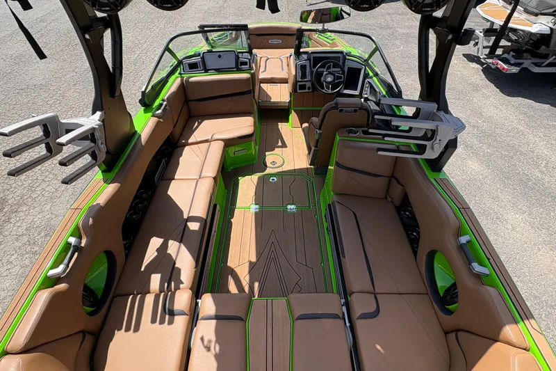 Slide: The Image of 2023 Supra SL 400 boat interior with tan seating and green accents. - 14