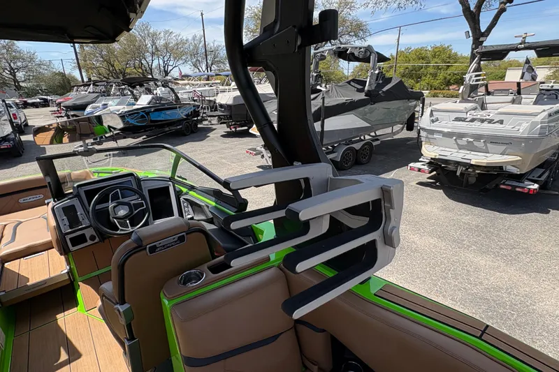 Slide: The Image of Interior of a 2023 Supra SL 400 boat with steering wheel and seating. - 16