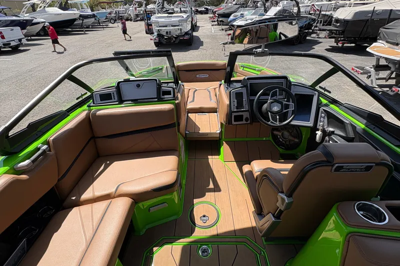 Slide: The Image of Interior of 2023 Supra SL 400 boat with tan seating and green accents. - 17