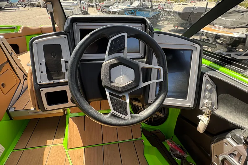 Slide: The Image of 2023 Supra SL 400 boat dashboard with steering wheel and digital displays. - 21