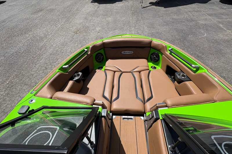 Slide: The Image of 2023 Supra SL 400 boat interior with green accents and brown seating. - 23