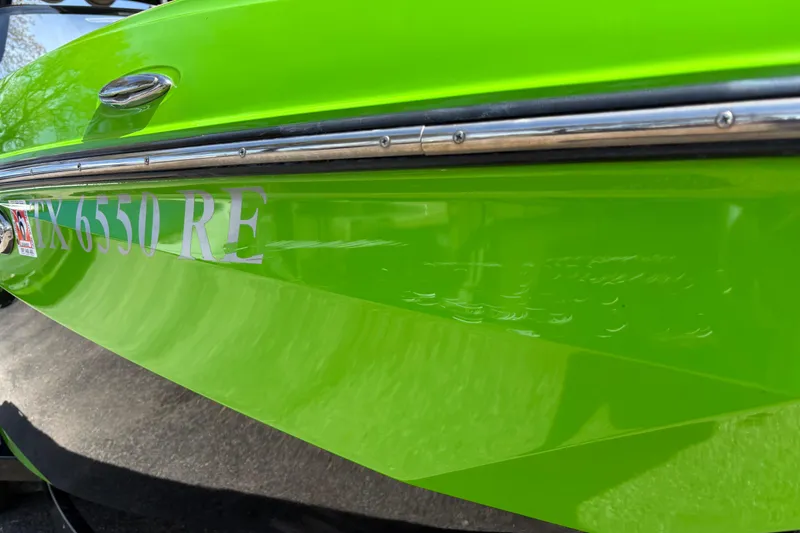 Slide: The Image of Bright green 2023 Supra SL 400 boat with registration TX 6550 RE. - 5