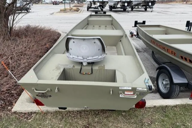 Slide: The Image of 2024 Tracker Grizzly 1436 Jon boat parked outdoors on a trailer. - 2