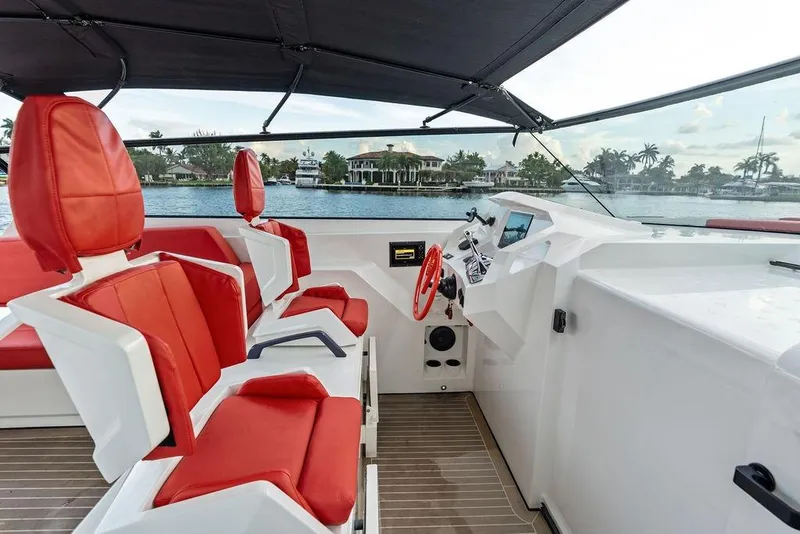 Slide: The Image of Luxurious 2016 Vanquish Yachts VQ48 interior with red seating and modern helm. - 11