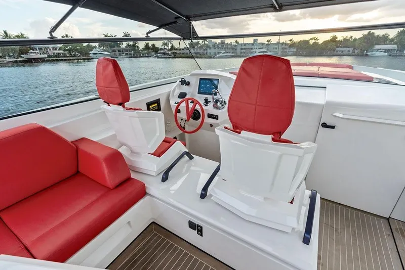 Slide: The Image of Luxurious 2016 Vanquish Yachts VQ48 interior with red seating and modern helm. - 12
