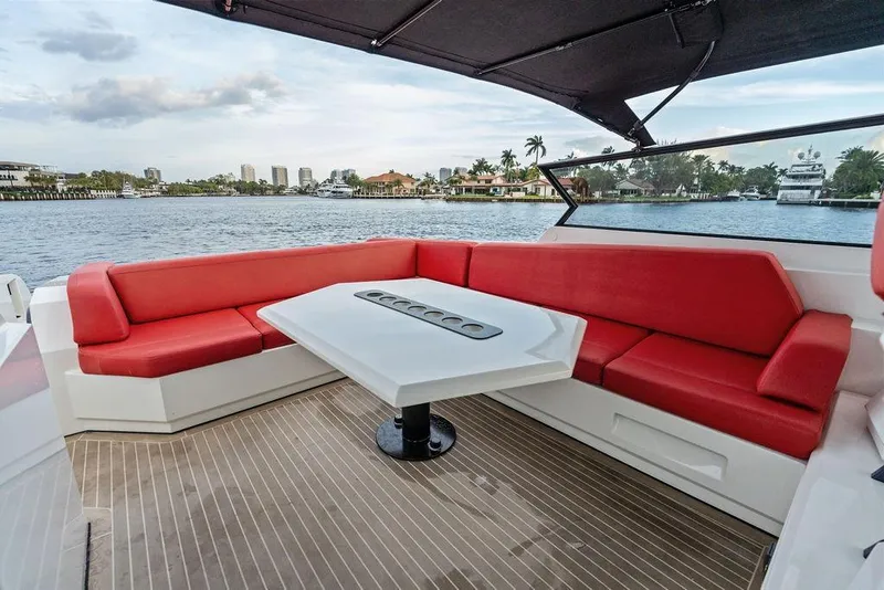 Slide: The Image of Luxurious 2016 Vanquish Yachts VQ48 with red seating and waterfront view. - 14