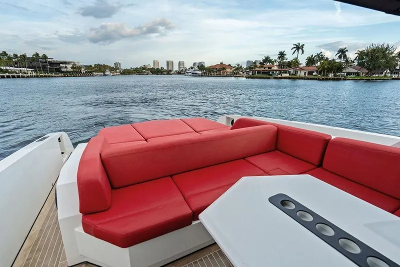 Slide: The Image of Luxurious 2016 Vanquish Yachts VQ48 with red seating, cruising on a scenic waterway. - 15