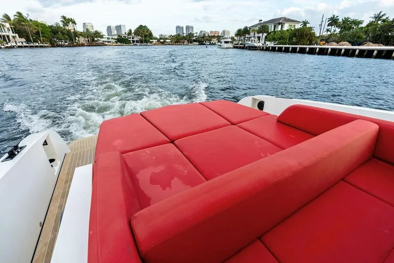 Slide: The Image of Red seating on 2016 Vanquish Yachts VQ48, cruising through scenic waterfront. - 16