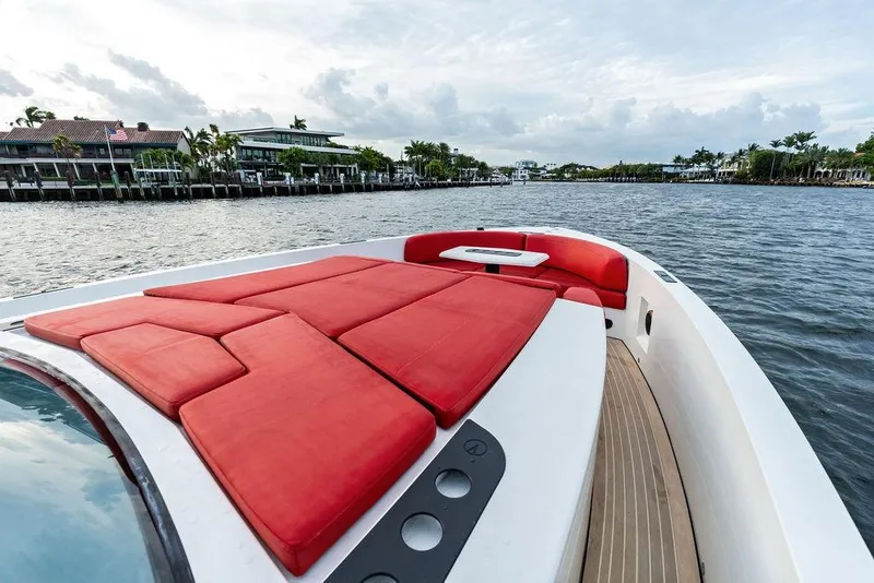 Slide: The Image of Luxurious 2016 Vanquish Yachts VQ48 with red seating, cruising on a scenic waterway. - 17