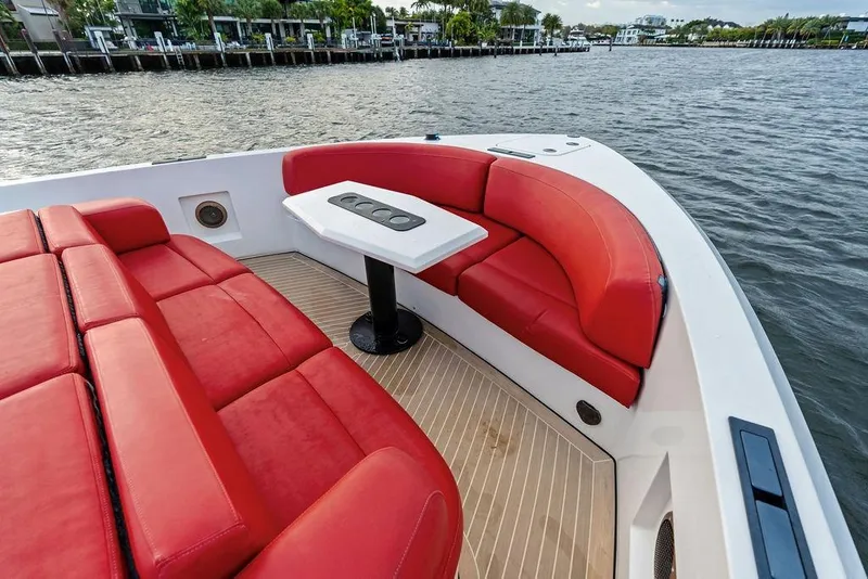 Slide: The Image of Luxurious 2016 Vanquish Yachts VQ48 with red seating and sleek design on the water. - 18