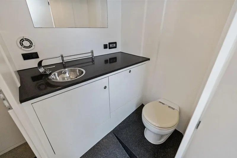 Slide: The Image of Luxurious bathroom in 2016 Vanquish Yachts VQ48 with sleek sink and modern toilet. - 25
