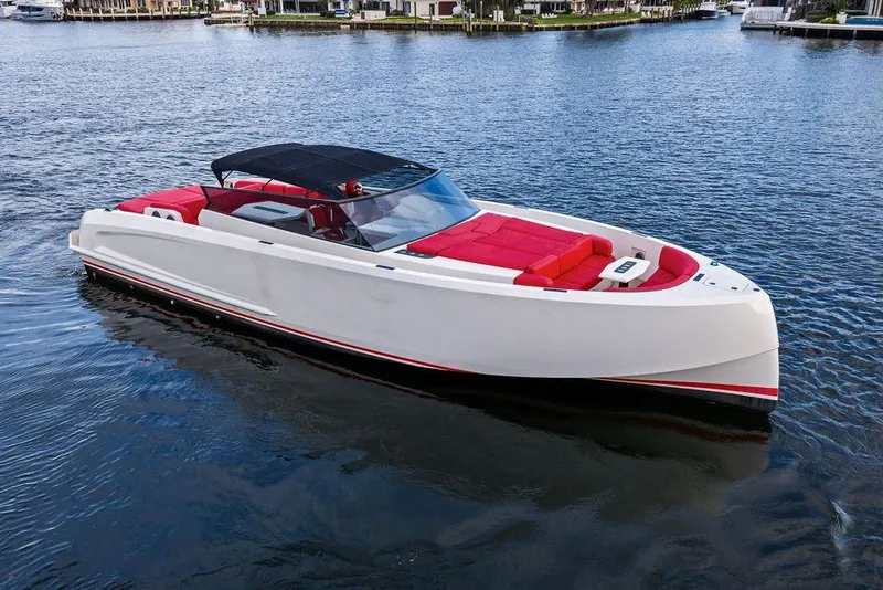 Slide: The Image of 2016 Vanquish Yachts VQ48 luxury yacht with red seating on calm water. - 3