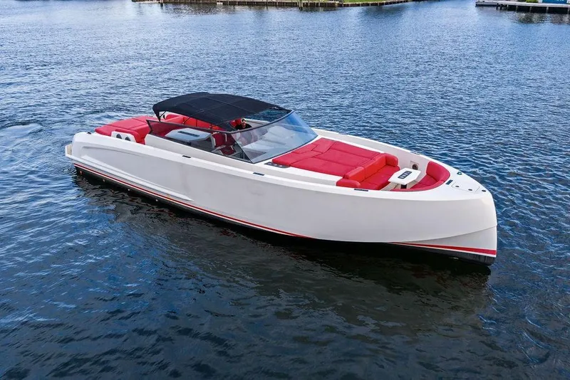 Slide: The Image of 2016 Vanquish Yachts VQ48 luxury yacht with red seating on calm water. - 5
