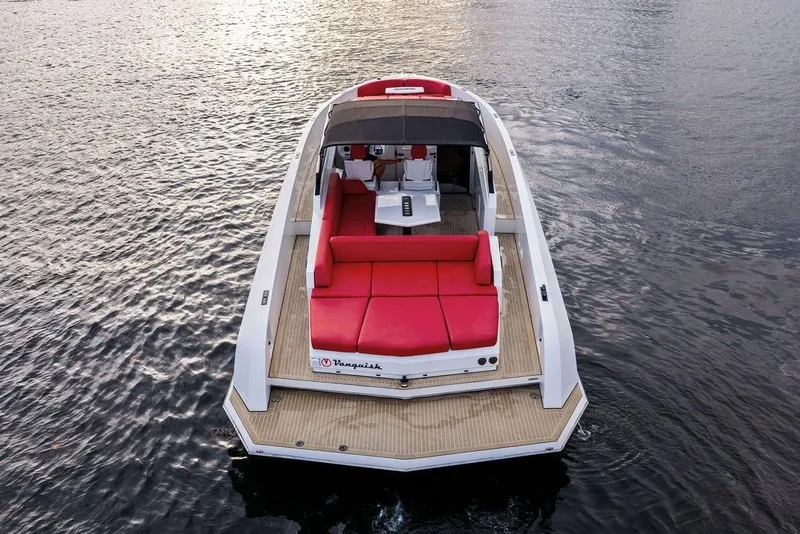 Slide: The Image of 2016 Vanquish Yachts VQ48 with red seating, cruising on calm waters. - 6