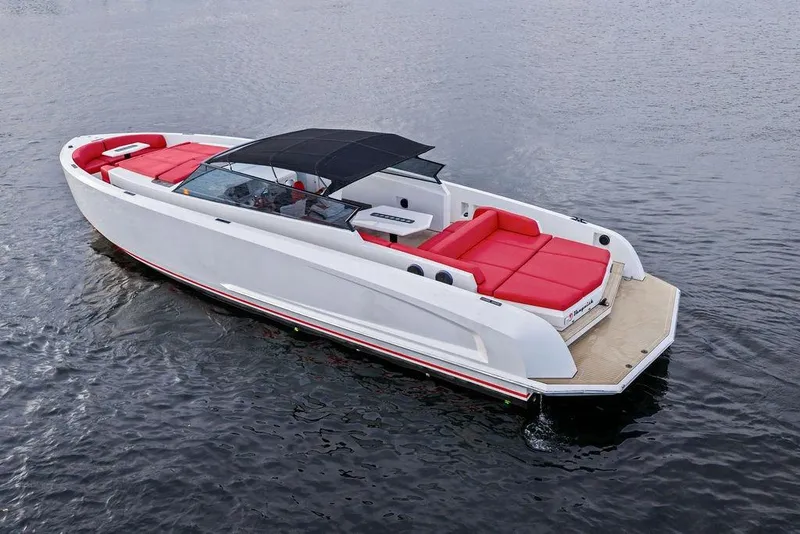 Slide: The Image of 2016 Vanquish Yachts VQ48 with red seating, sleek design on calm water. - 7