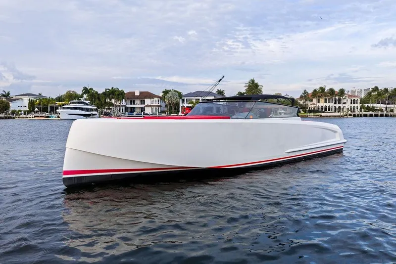 Slide: The Image of 2016 Vanquish Yachts VQ48 luxury yacht on calm water, with scenic waterfront backdrop. - 9