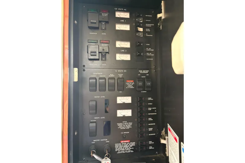 Slide: The Image of Electrical panel of a 2000 Sea Ray 340 Sundancer boat, showing switches and controls. - 19