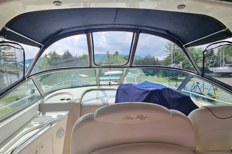 Slide: The Image of Interior view of a 2000 Sea Ray 340 Sundancer boat cockpit with covered controls. - 2